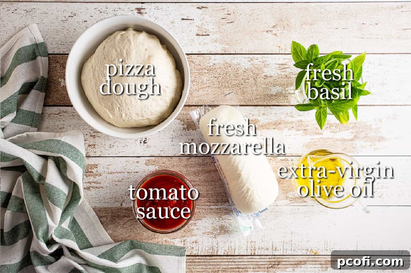 A perfectly arranged flat lay of fresh ingredients for making Margherita pizza, including dough, tomatoes, mozzarella, and basil.