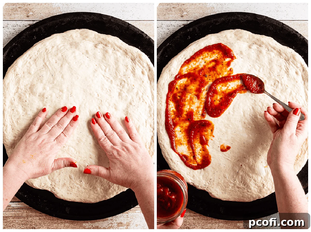 Expert hands stretching homemade pizza dough over a pizza pan, followed by spreading a thin, even layer of rich tomato sauce.