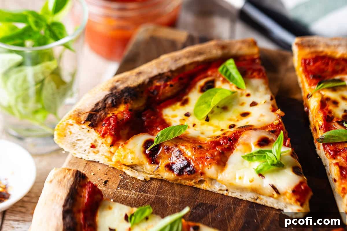 A close-up, artfully composed image of a homemade Italian pizza Margherita, with fresh tomatoes and basil subtly blurred in the background, highlighting the pizza's delicious details.