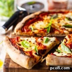 Margherita pizza fresh from the oven and presented on a wooden cutting board.