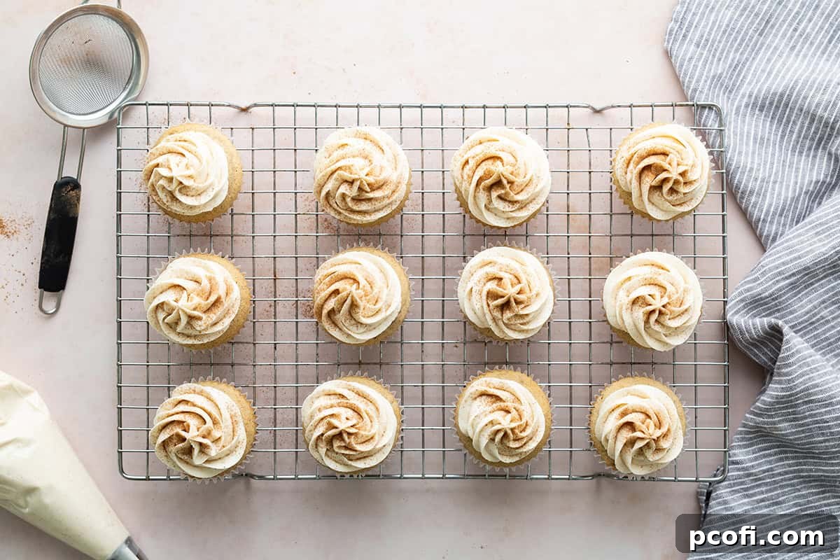 Chai spice delicately sifted on top of frosted cupcakes, adding a final aromatic and visual flourish.