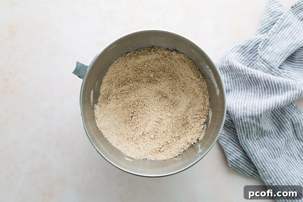 Softened butter mixed into the dry cupcake ingredients, creating a crumbly, sandy texture.