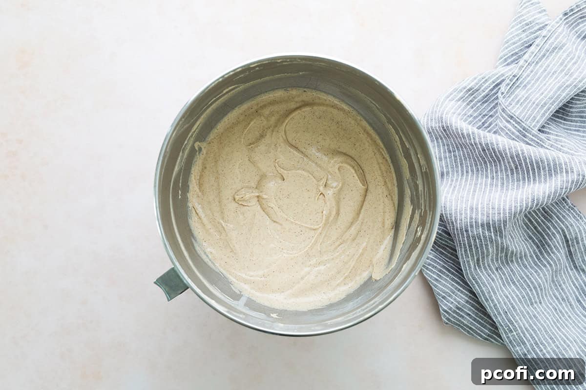 Smooth cupcake batter for chai cupcakes in a stand mixer bowl, showcasing its readiness for baking.