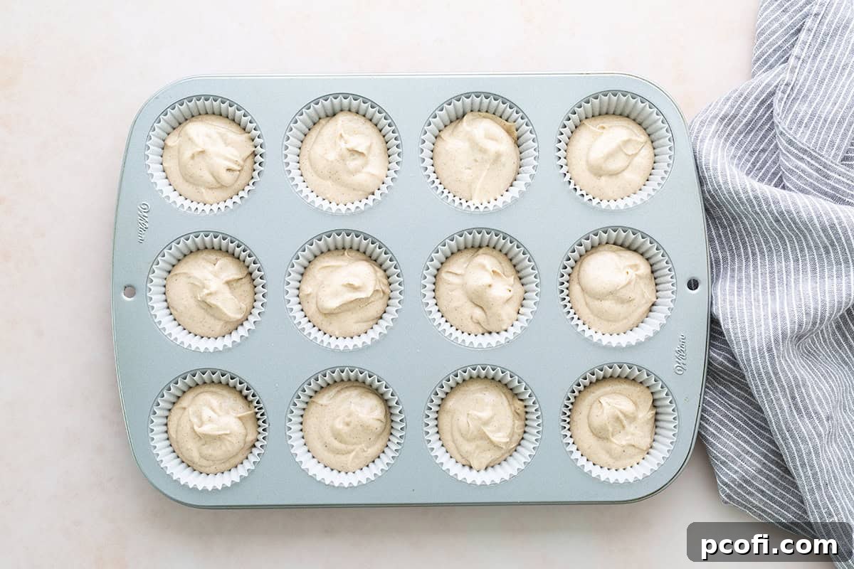Cupcake batter carefully divided into cupcake liners, ready for the oven.