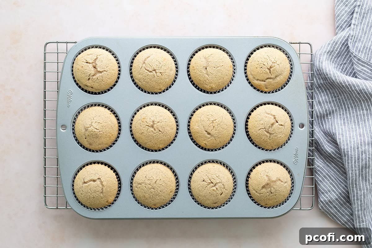 Freshly baked chai cupcakes cooling on a wire rack, ready for frosting.