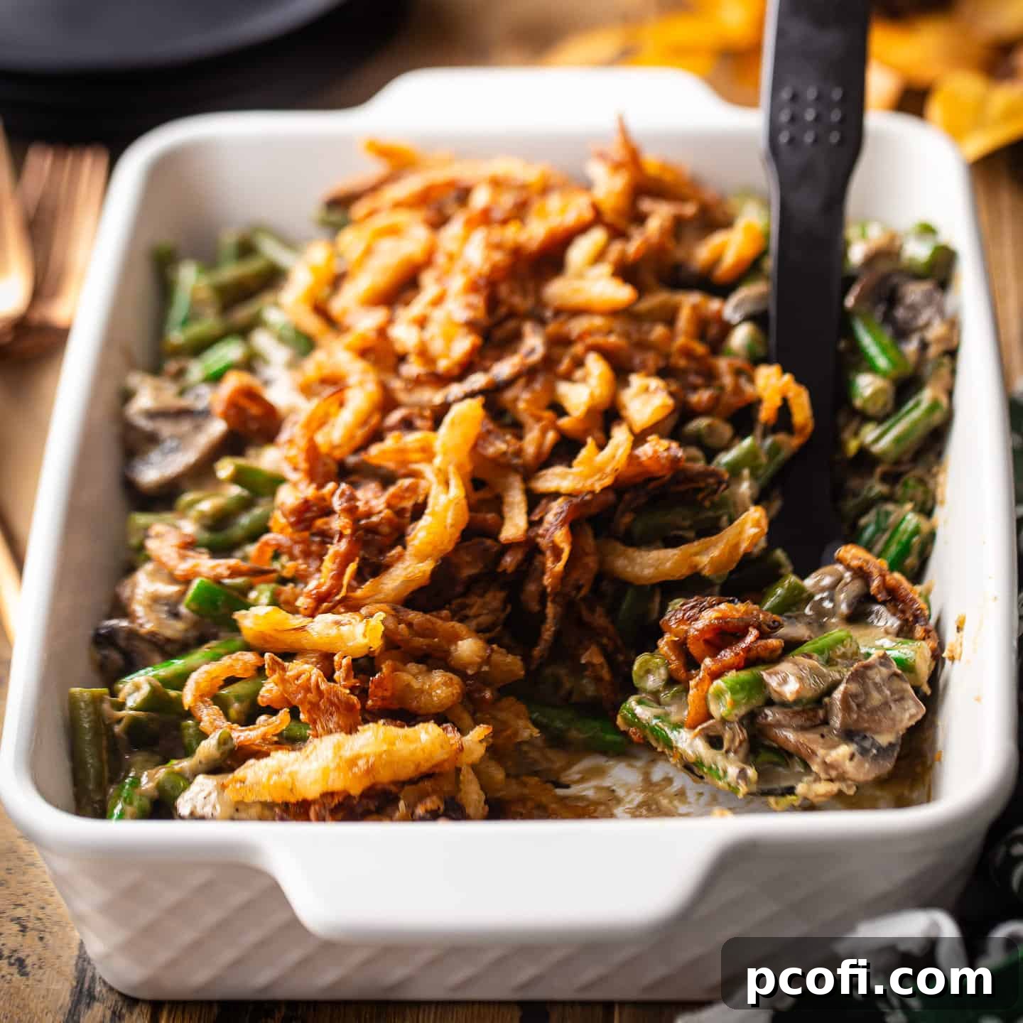 Homemade green bean casserole, freshly baked in a casserole dish and generously topped with crispy French fried onions.