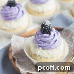 Delicious Blackberry Coconut Cupcakes with frosting and fresh fruit.