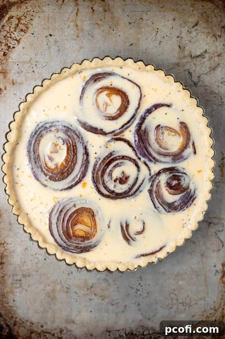 cream, milk and egg mixture poured over onions