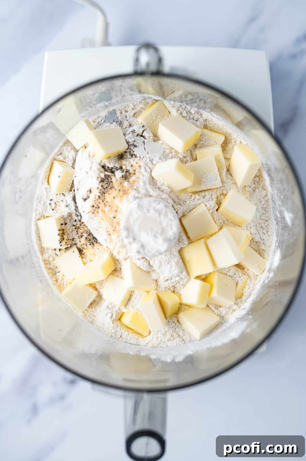 flour, butter and spices in the bowl of a food processor