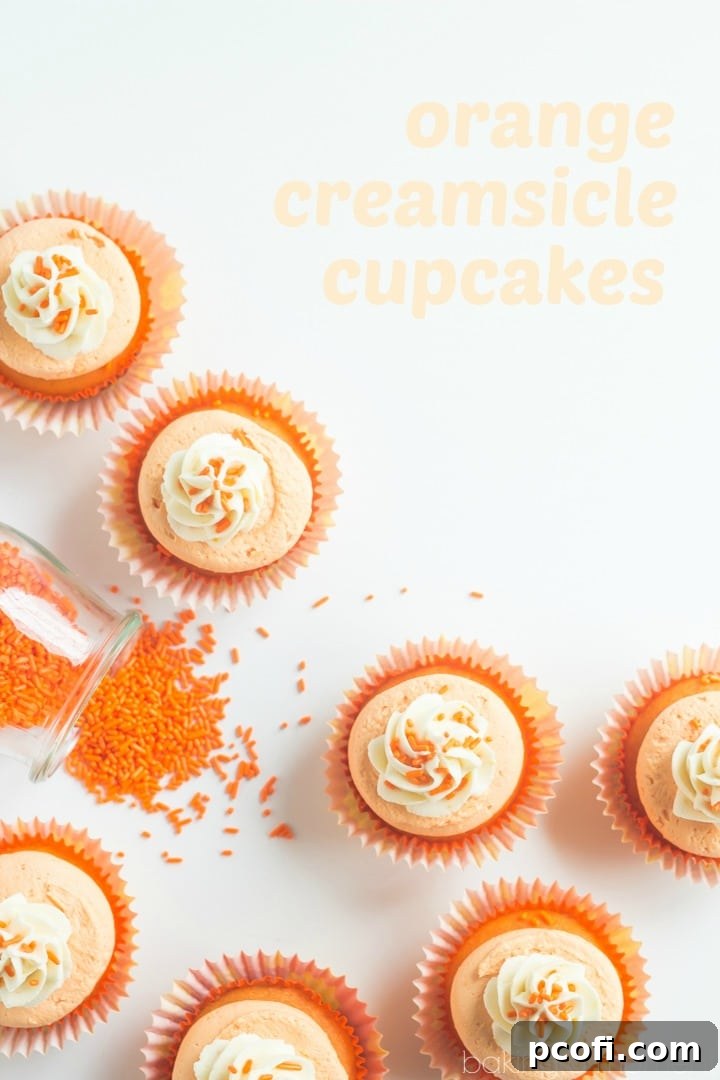 A close-up of beautifully decorated Orange Creamsicle Cupcakes, highlighting the fluffy frosting.