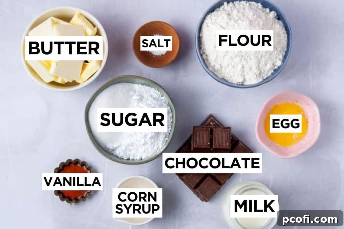 A flat lay photograph showcasing all the ingredients for Millionaire Shortbread, including butter, sugar, flour, chocolate, and cream.