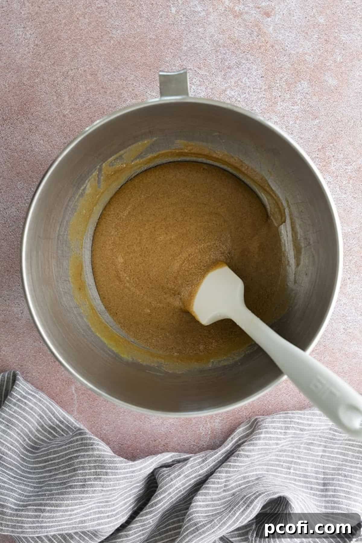 All wet ingredients, including eggs and vanilla, fully combined and smooth in a mixing bowl, ready for dry ingredients.