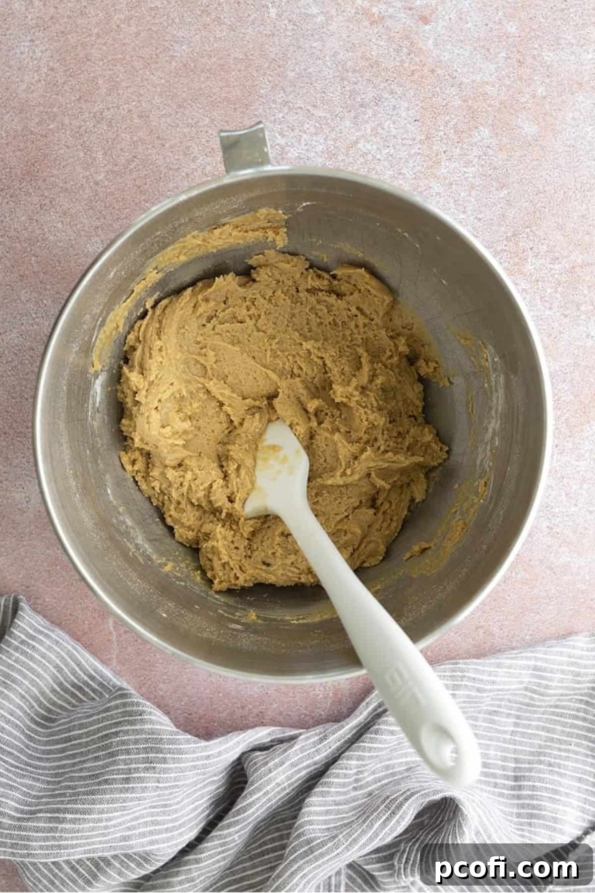 The blondie cookie dough in a stainless steel bowl, after dry ingredients have been mixed in, showing its consistent texture.