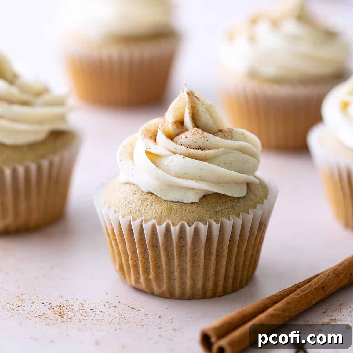 Delicious Chai Spice Cupcakes, garnished with cinnamon sticks and cloves, embodying the warm and inviting aromas of the holiday season.