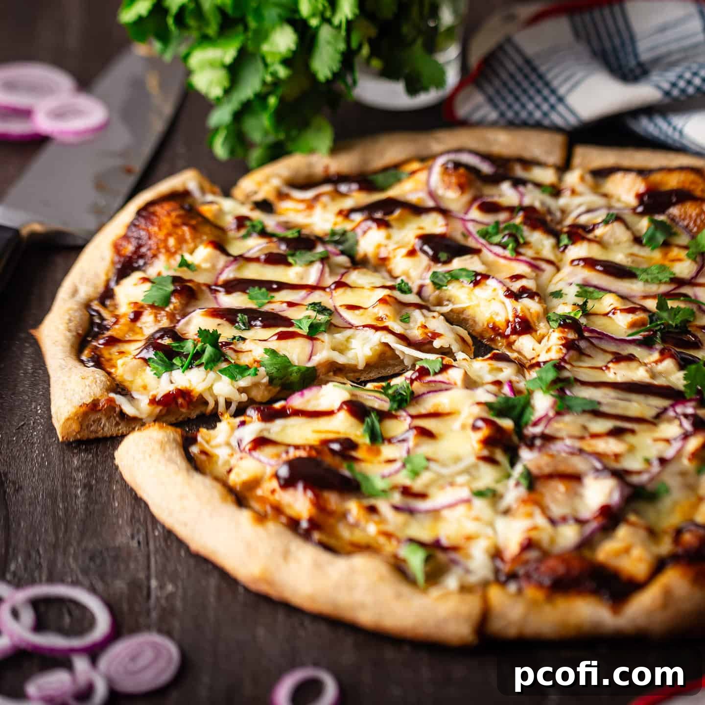 A mouth-watering homemade barbecue chicken pizza, generously sprinkled with fresh cilantro leaves for a vibrant finish.