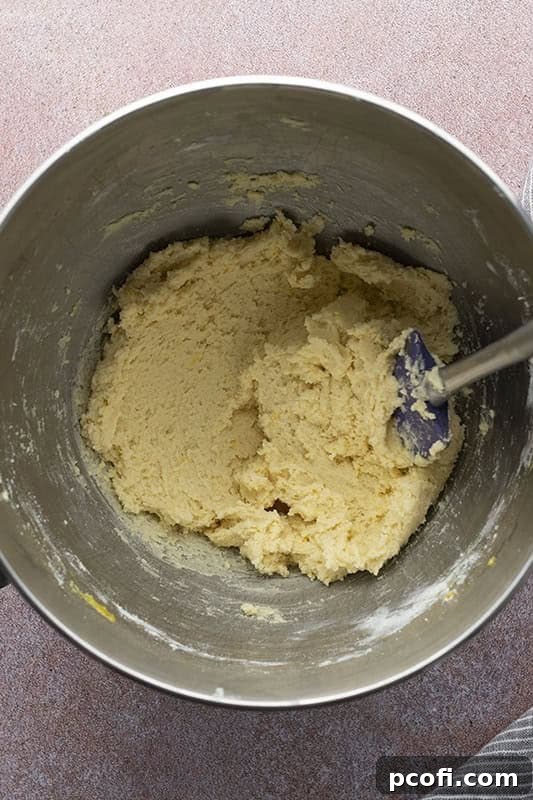 Adding egg, lemon, vanilla, and flour mixture.