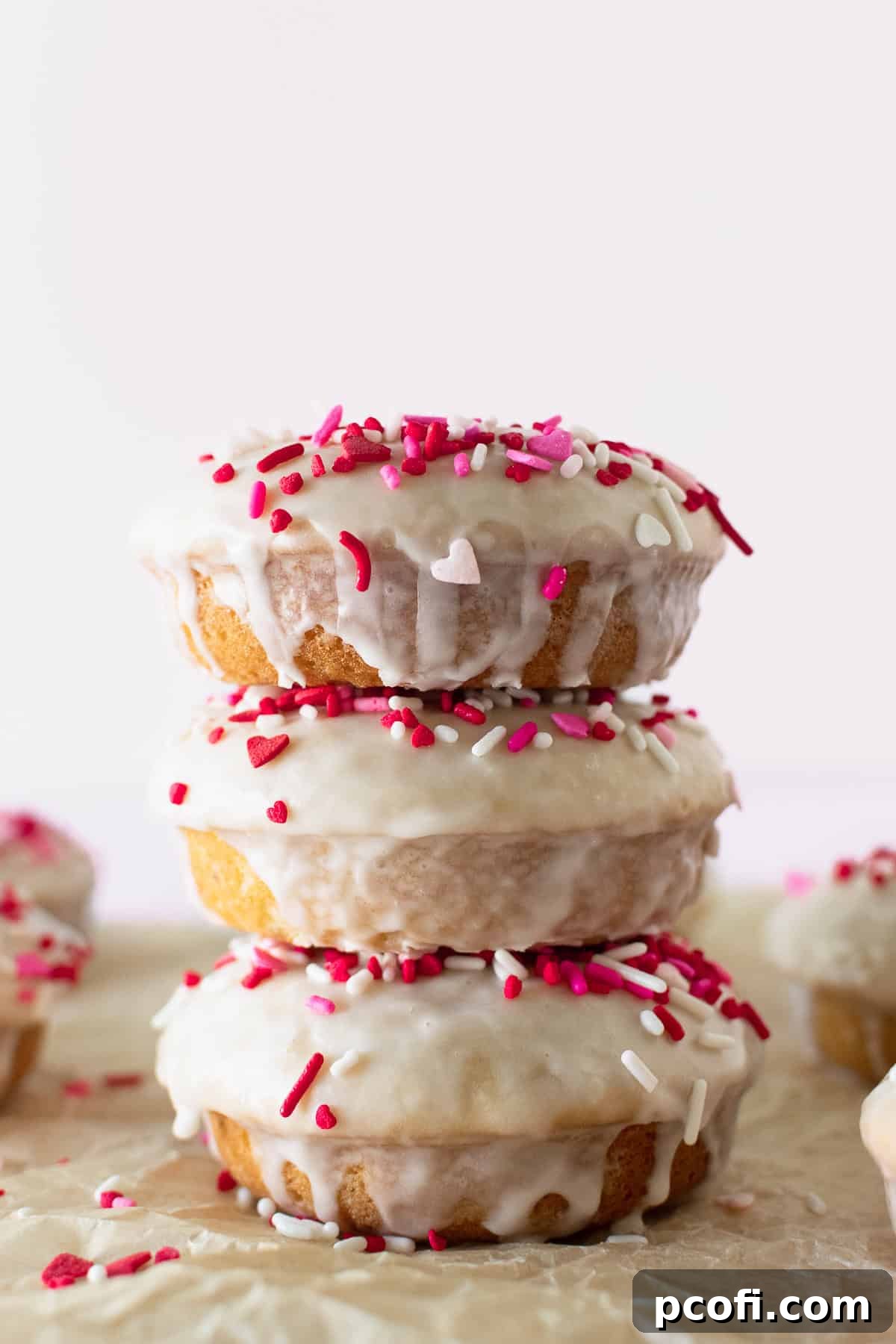 stacked glazed donuts with Valentine's Day sprinkles.