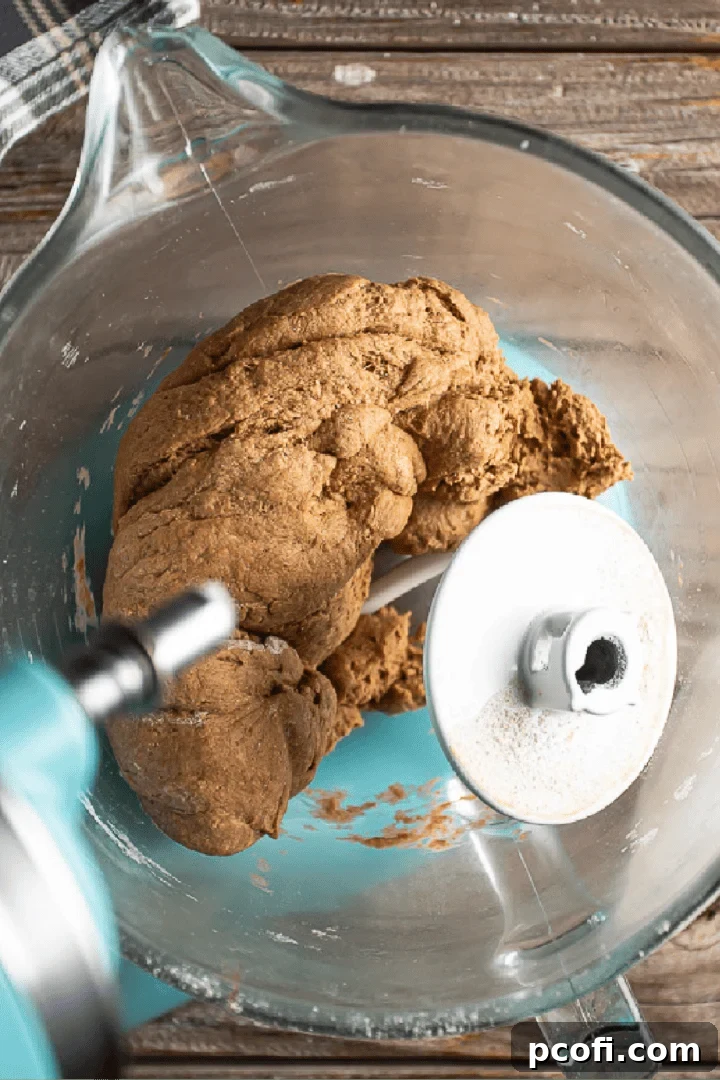 Mixing Outback bread dough to the proper consistency, gathering into a ball.