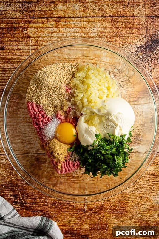 Step 1: All meatball ingredients are placed in a large mixing bowl, ready for combining.