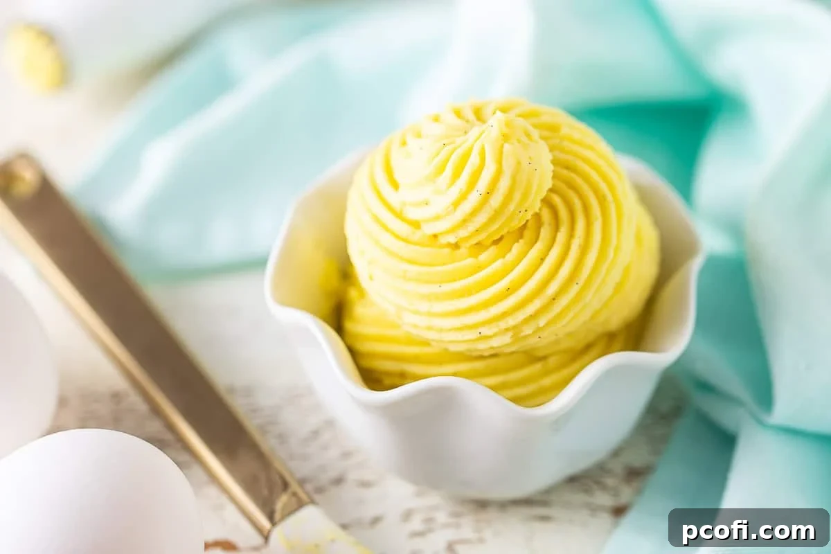 A side view of a vanilla bean German buttercream cake, showing the smooth, piped frosting.