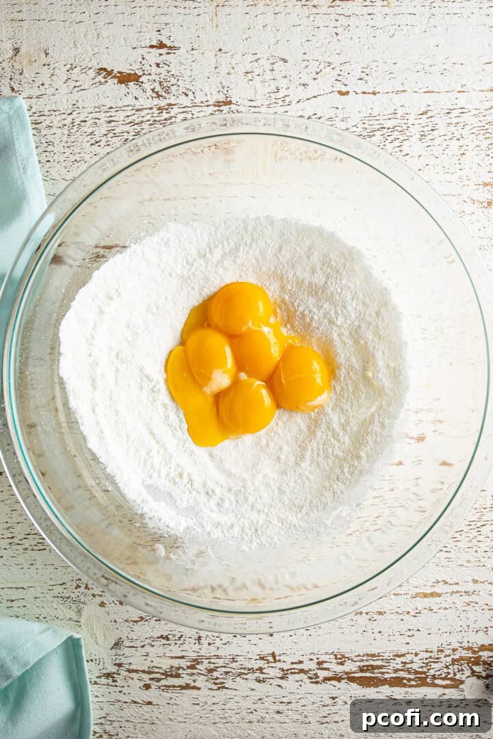 Dry ingredients (sugar, cornstarch, salt) being combined in a bowl.