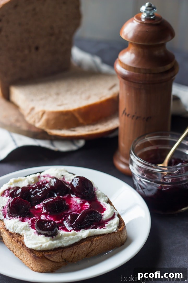 Delicious Homemade Red Grapeseed Wheat Bread served with creamy ricotta, sweet cherries, and a sprinkle of black pepper. A gourmet twist on wholesome bread. #breadrecipe #ricottatoast