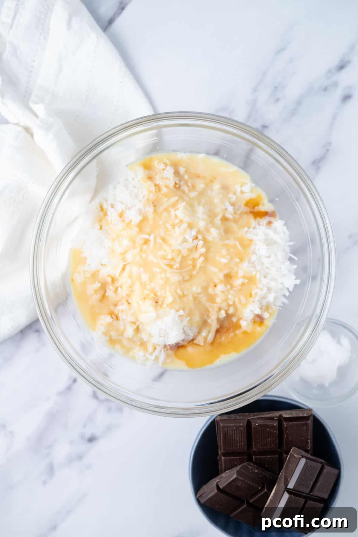 coconut flakes, sweetened condensed milk, vanilla and coconut extract in a mixing bowl