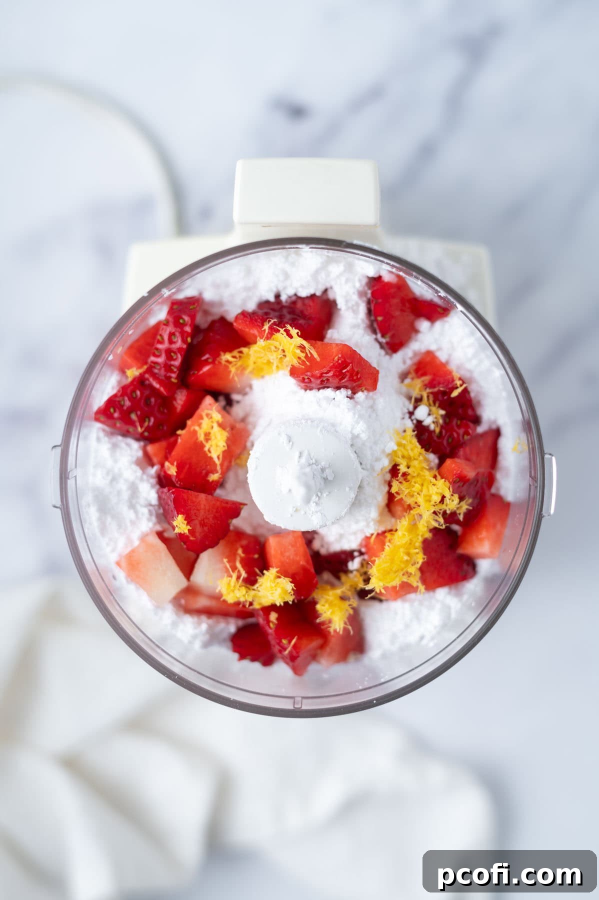 powdered sugar, chopped fresh strawberry and lemon zest in the bowl of a food processor