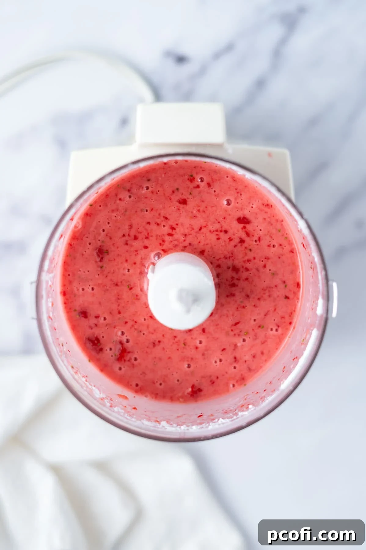 fresh strawberry donut glaze in the bowl of a food processor