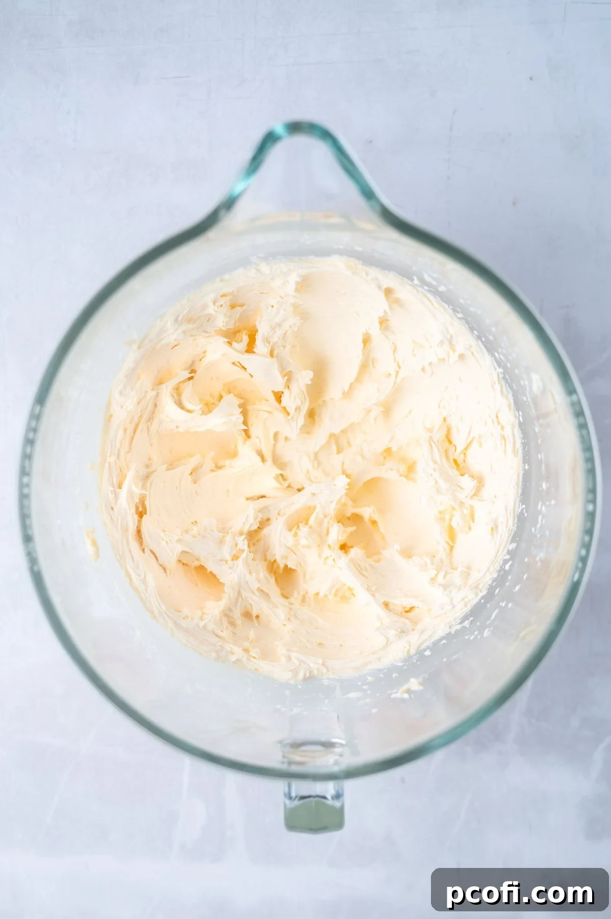Creamy yellow custard buttercream filling sits in a mixing bowl, showing its smooth texture.