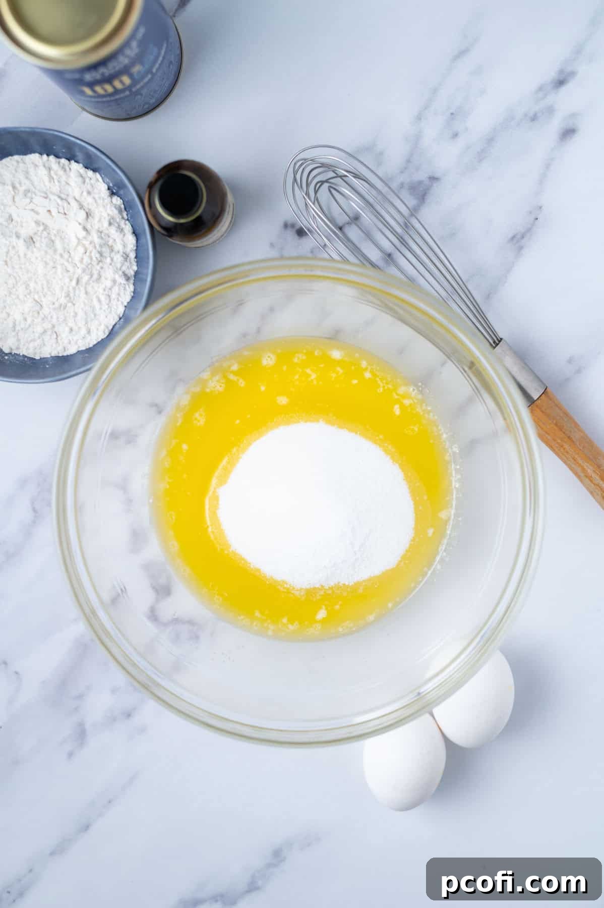 Step 1: In a mixing bowl, melted butter, granulated sugar, and kosher salt are whisked together until fully combined, showing a smooth, shimmering mixture.