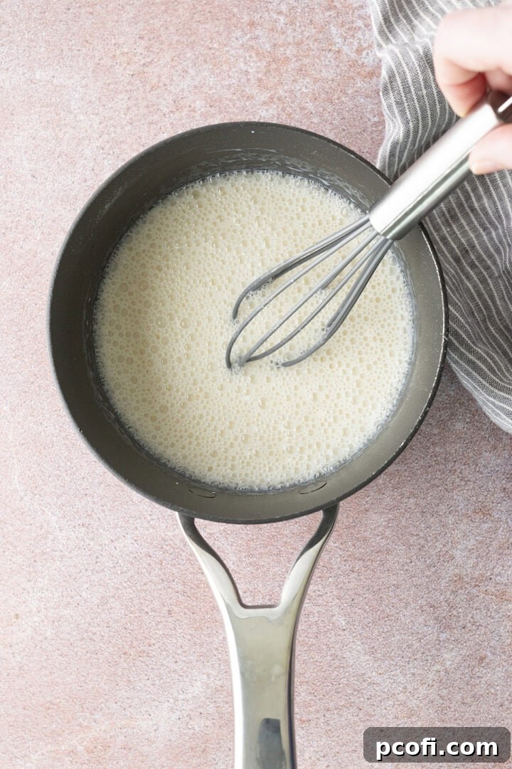 Milk whisked into dry ingredients in a saucepan