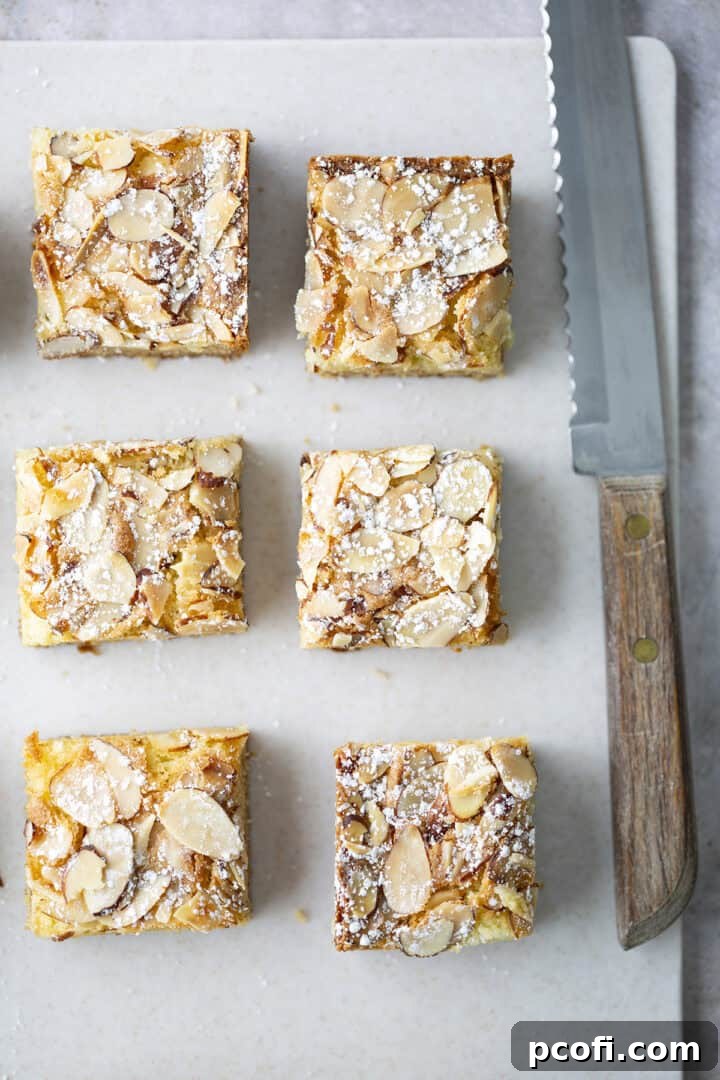 Almond Blondies on a cutting board with a knife, ready to be served