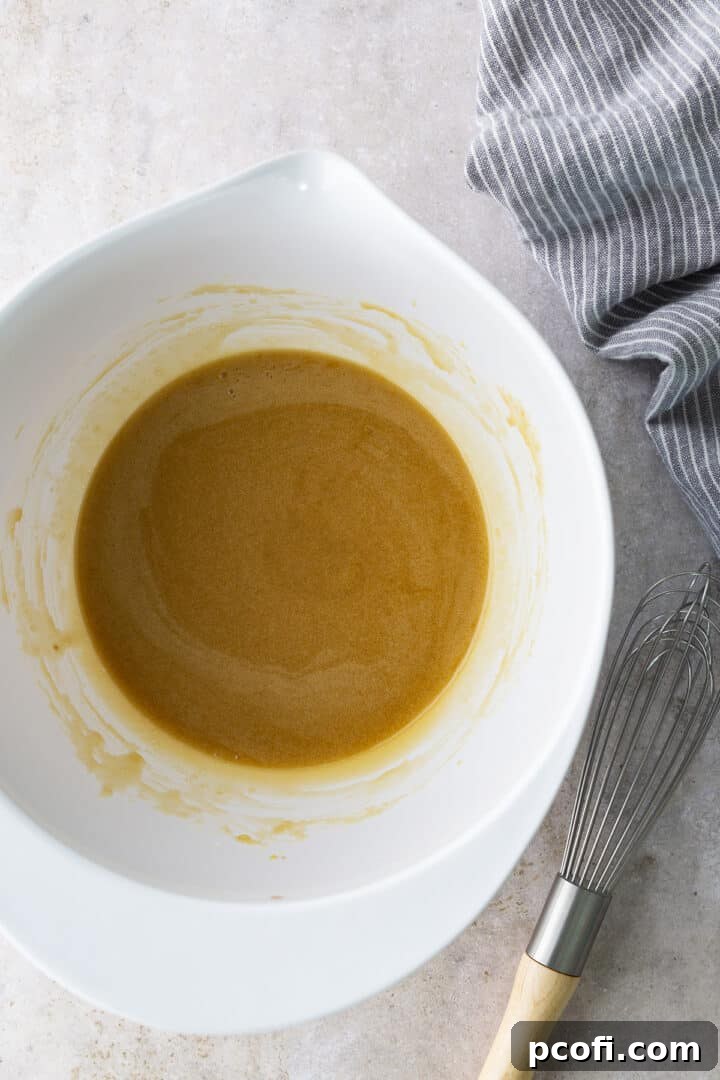 Wet ingredients for blondie batter in a bowl, a golden mixture