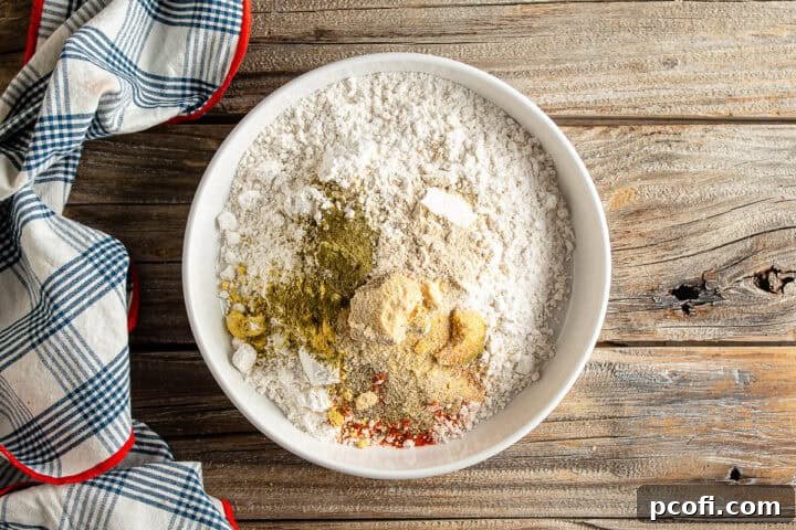 All the dry ingredients for the perfectly seasoned breading, laid out for homemade chicken tenders.