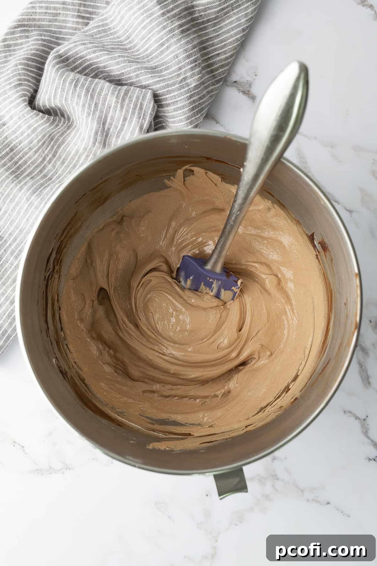 Finished Chocolate Ermine Frosting, smooth and rich, in a bowl, ready for use.