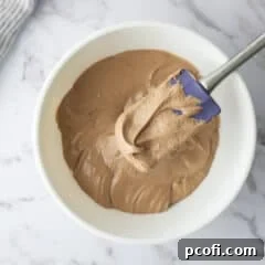Chocolate Ermine Frosting in a bowl with a spatula