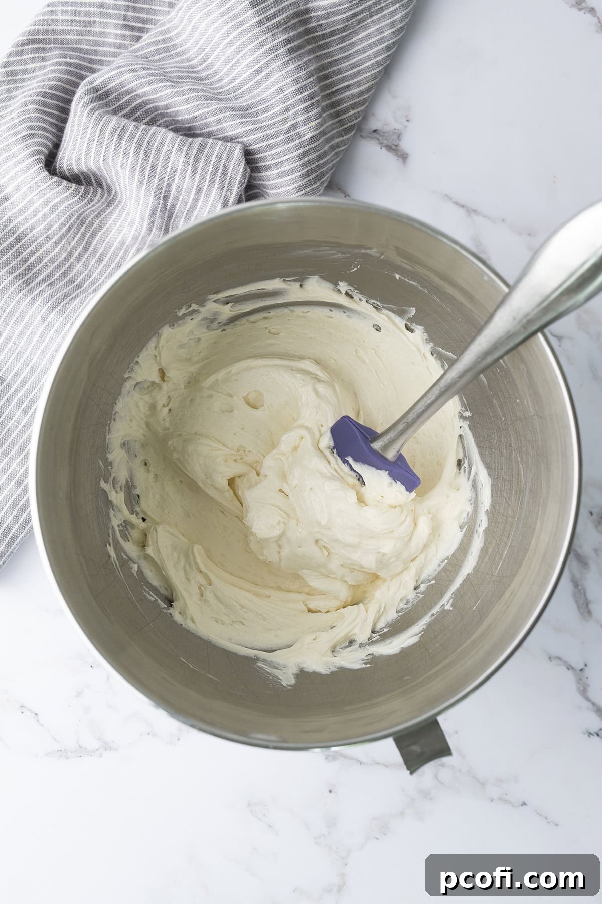 Light and fluffy ermine frosting being whipped to perfection in a stand mixer.