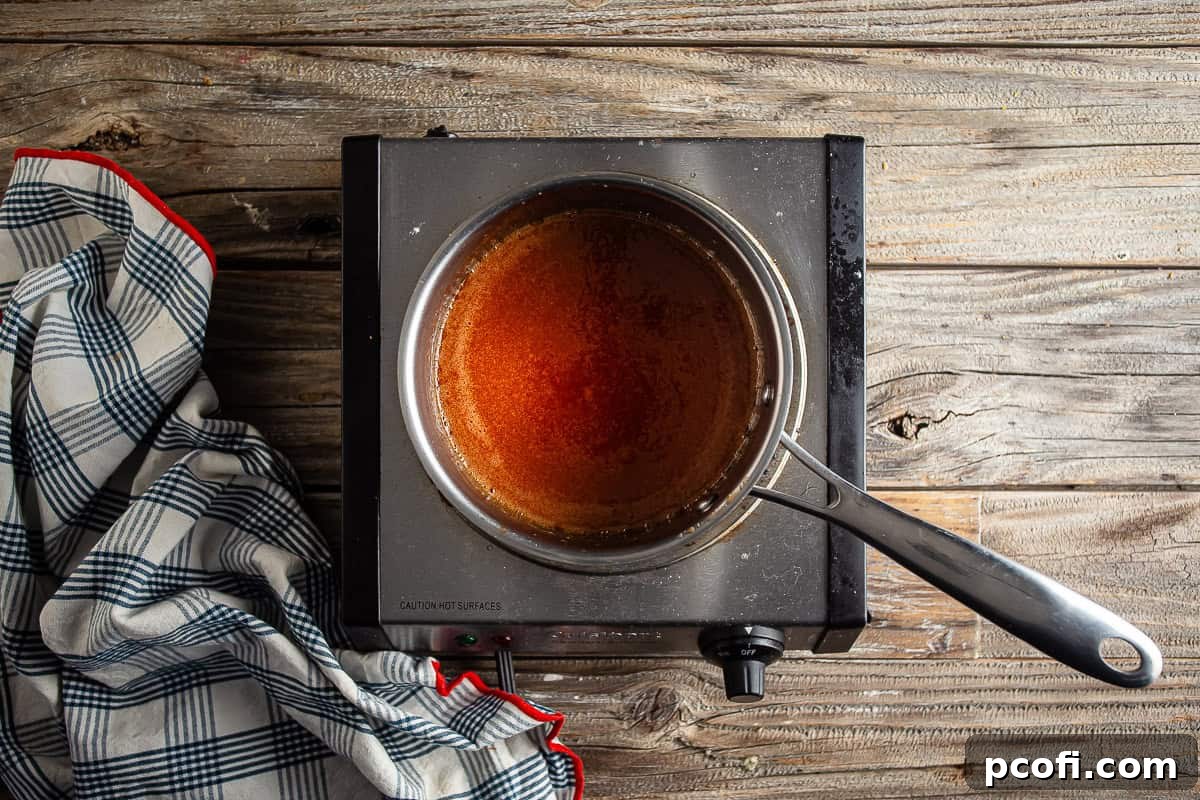 Whisking honey, hot sauce, and melted butter together until smooth and fully blended.