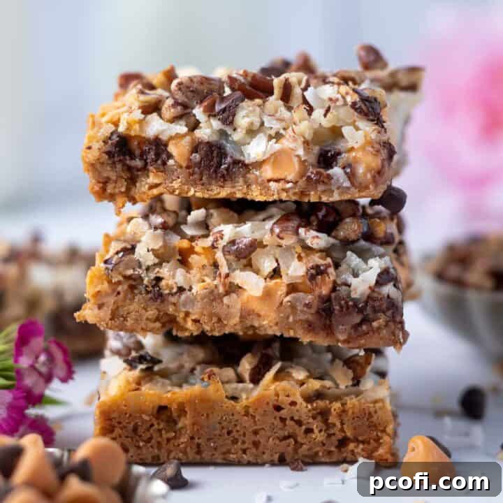 stack of magic bars with a bowl of chocolate and butterscotch chips