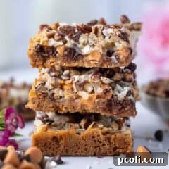 stack of magic bars with a bowl of chocolate and butterscotch chips