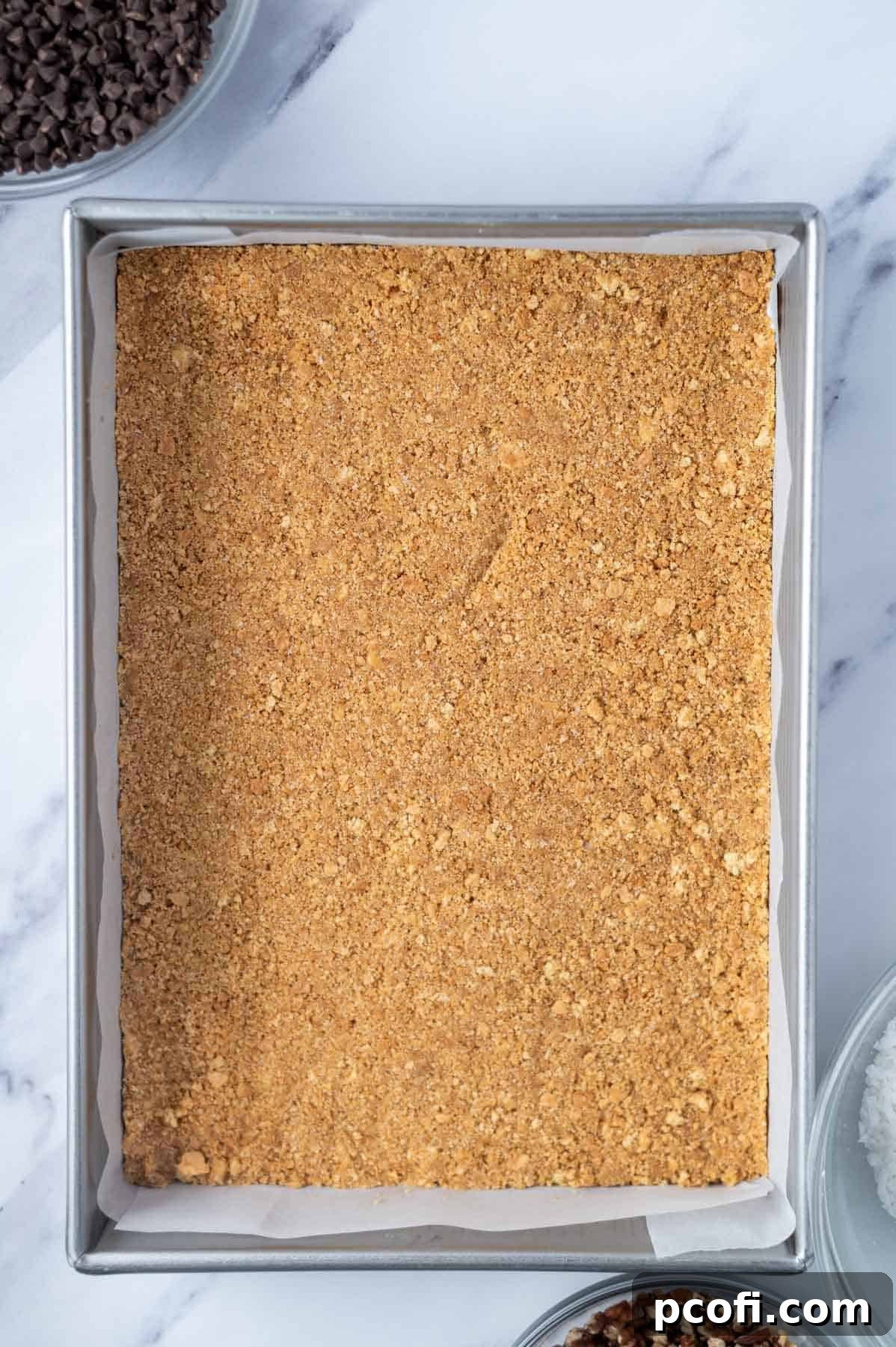 graham cracker crust pressed into a parchment lined baking pan