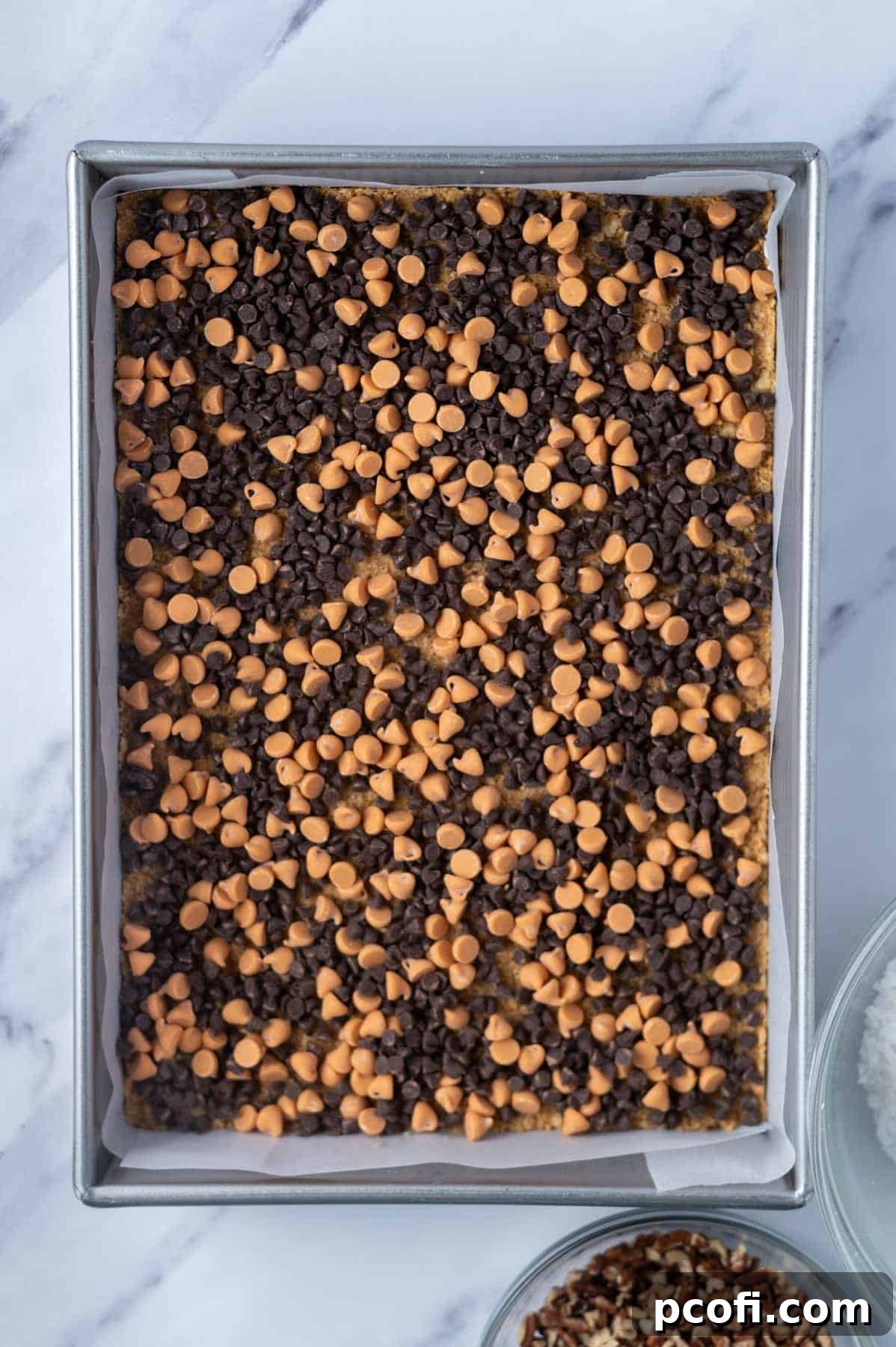 mini chocolate chips and butterscotch chips layered over graham cracker crust