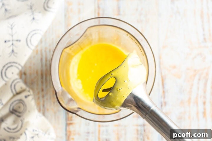 A stick blender after blending the egg yolk, lemon juice, and kosher salt for béarnaise sauce.