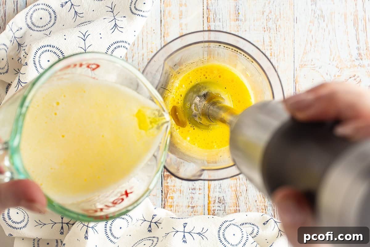 A stick blender mixing the hot butter into the bearnaise base. 