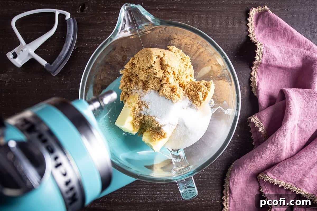 Sugars and butter in a large mixing bowl before being creamed together.