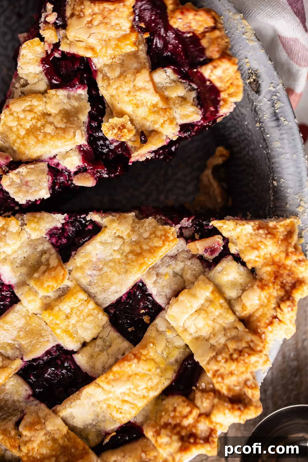 Blackberry pie with a slice removed.