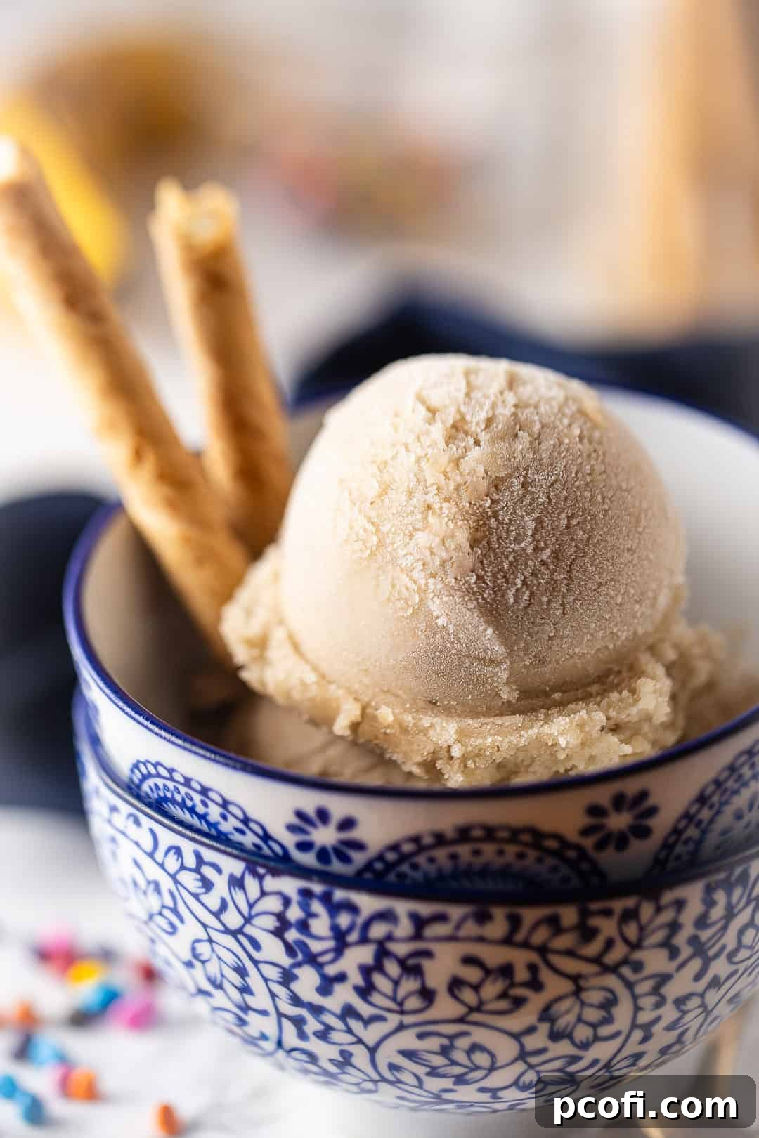 Banana Nice Cream in decorative bowls with cookies in the bowl.