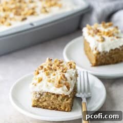 A slice of Zucchini Cake on a plate, showing off the fluffy cake and rich frosting.