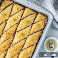 Finished Baklava in the pan, garnished with pistachios.